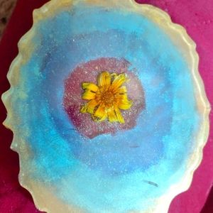 Real flower in liquid glass. Yellow, blue, green. Hand made coaster